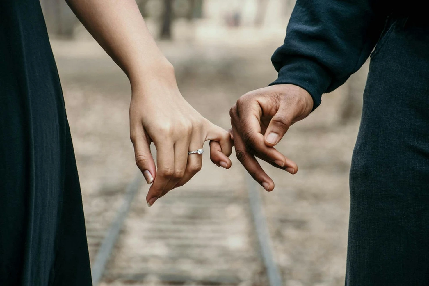 A woman and man holding hands | Image Source: Pexels