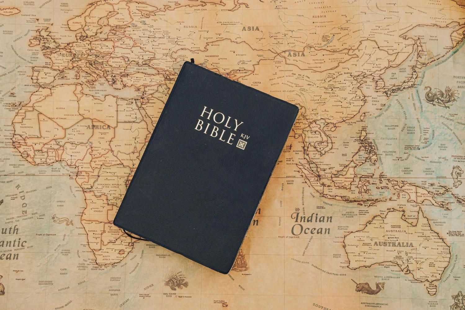 Holy bible placed on a map | Image Source: Pexels